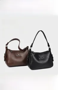 Detail of premium textured leather tote bags with metal kangaroo logo and multi-compartments
