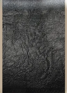 Close-up of premium black lychee pattern leather with a soft matte finish and fine texture