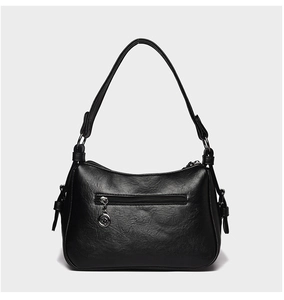 Detailed back view of black faux leather handbag featuring a functional zipper pocket