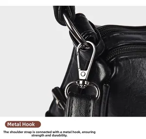 Detailed macro of silver metal clasp on black lychee grain leather shoulder bag