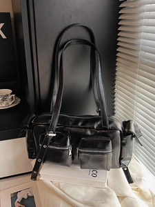 Minimalist black faux leather hobo bag with multi-pocket utility design and silver hardware