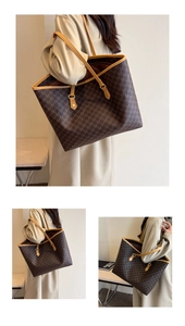 Detail of a large brown tote bag with repeating M patterns and tan leather handles
