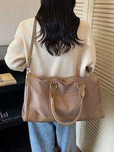 Beige nylon travel bag with large capacity for gym and weekend trips shown in home setting