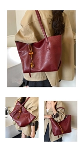 Detail view of burgundy tote bag with vintage leather texture and wooden bead tassel decor