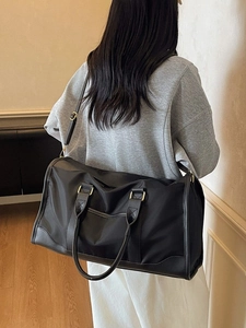 Large black waterproof travel bag with leather trim and shoulder strap for fitness