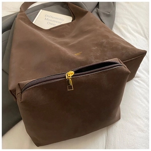 Detail view of vintage brown tote bag set with matching small zipper pouch and gold logo