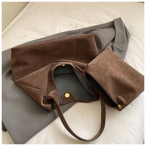 Detail of dark brown suede tote bag set with inner zipper pouch and soft texture