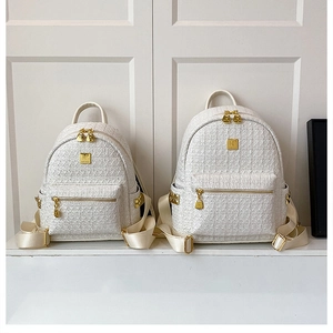 Detailed comparison of two sizes of creamy tweed backpacks with golden K logo hardware