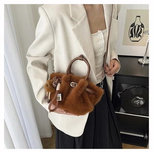 Detailed view of brown plush tote bag with ruched faux fur and leopard print bow