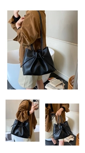 Detail der schwarzen Leder-Beuteltasche mit geknoteten Riemen und weicher Lederstruktur