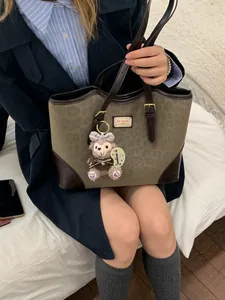 Retro leopard print tote bag with brown leather trim and cute plush charm detail