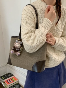 Retro leopard print tote bag with brown leather handles and cute plush charm detail