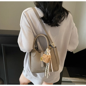 Sac seau taupe en cuir grainé avec pendentif ours et détail de ruban élégant