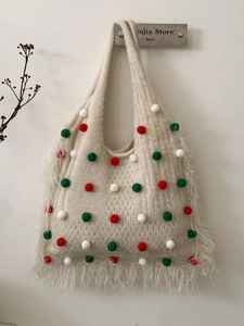 Beige knit tote bag with colorful pom-poms and long side tassels in bohemian style