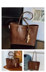 Brown woven texture tote bag with vintage beads tassel detail and shoulder strap