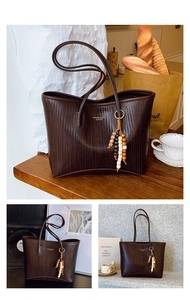 Detailed texture of dark brown woven PU tote bag with bohemian beaded accessory charm