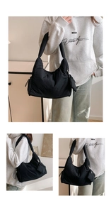 Detail view of quilted black tote bag with matching hanging coin purse and wide strap