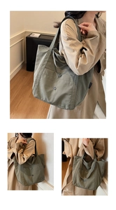 Detail view of large olive green canvas tote bag with front pocket and magnetic closure