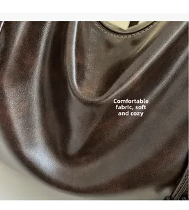 Close-up detail showing the soft dark brown vintage oil wax leather texture of this tote bag
