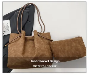 Detailed view of brown suede tote bag with drawstring closure and matching inner pouch