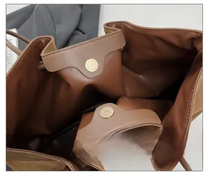 Detail of vintage brown leather tote showing double magnetic closure and drawstring top