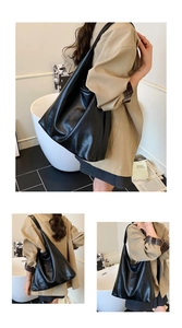Detail of black pebbled PU leather tote with wide strap and minimalist slouchy design