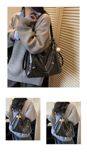 Detail of black glossy tote bag with silver hardware and baseball charm on model
