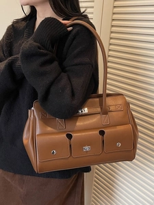 Vintage brown faux leather underarm bag with three front pockets and metal buckles