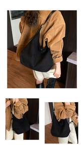 Detail view of large black faux suede hobo bag showing versatile shoulder and crossbody wear
