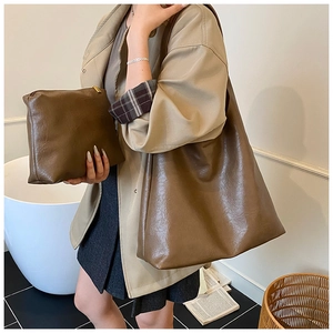 Detail of dark brown tote bag set with wrinkled PU leather and matching clutch bag