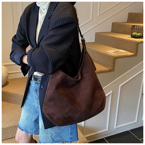 Detail of dark brown faux suede hobo bag showing matte texture and large capacity