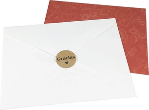 Macro view of round kraft Gracias stickers with heart on a white envelope seal