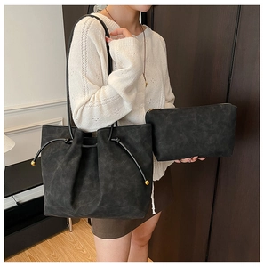 Detail of retro charcoal tote bag with inner pouch showing matte texture and drawstring