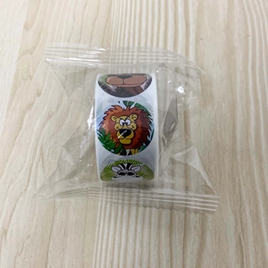 Detail of cartoon animal sticker roll featuring lions and zebras in clear packaging