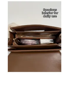 Internal view of brown leather crossbody bag showing large capacity with compartments