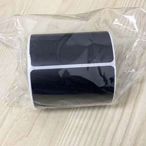Macro shot of roll-packed black removable chalkboard labels in clear plastic packaging