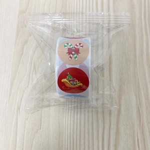 Roll of Christmas decorative stickers with candy cane and sleigh patterns in plastic bag