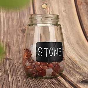 Roll of black chalkboard stickers on glass jar filled with decorative stones for home kitchen