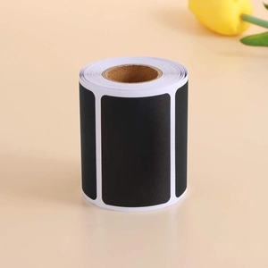 Removable blackboard sticker roll in matte black with rectangular labels on orange backdrop