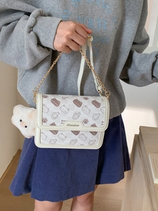 Cute cream-colored crossbody bag with cartoon bread cat prints and gold chain strap