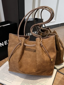 Brown frosted leather tote bag with drawstring design and slender shoulder straps