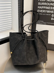 Retro minimalist black matte leather tote bag with gold metal bead drawstring detail