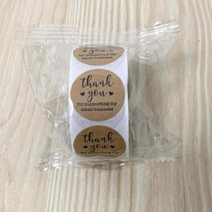 Macro view of kraft paper thank you stickers roll for small business packaging