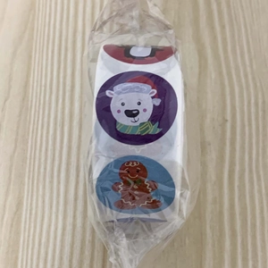 Detail of Christmas roll stickers featuring cartoon polar bear and gingerbread man designs
