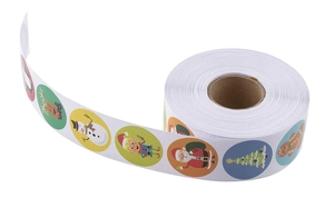 Close-up of a roll of colorful Christmas stickers featuring Santa, reindeer and snowman