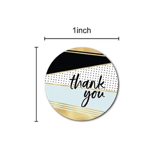 Roll of 1 inch round thank you stickers with geometric blue and gold patterns