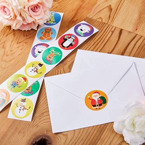 Close-up of colorful Christmas cartoon stickers on a roll for gift wrapping and envelopes