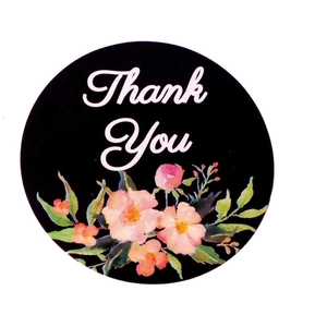 Floral Thank You stickers roll with black background and pink flowers on white backdrop