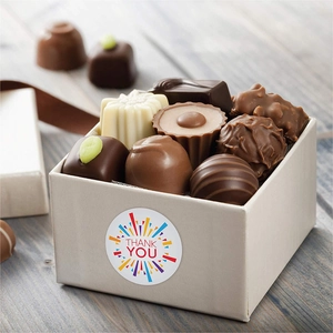 Detail of round Thank You sticker on a gourmet chocolate gift box with colorful lines