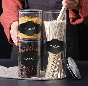 Macro view of clear glass storage jars with silver lids and black cacao labels